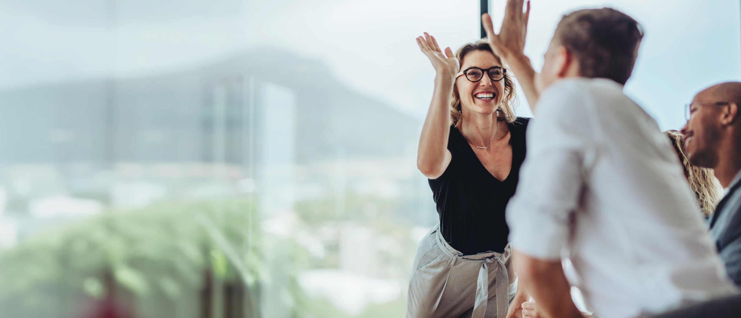 People cheering high five workplace great place to work